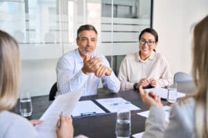 Diverse professional executive team people working at board meeting
