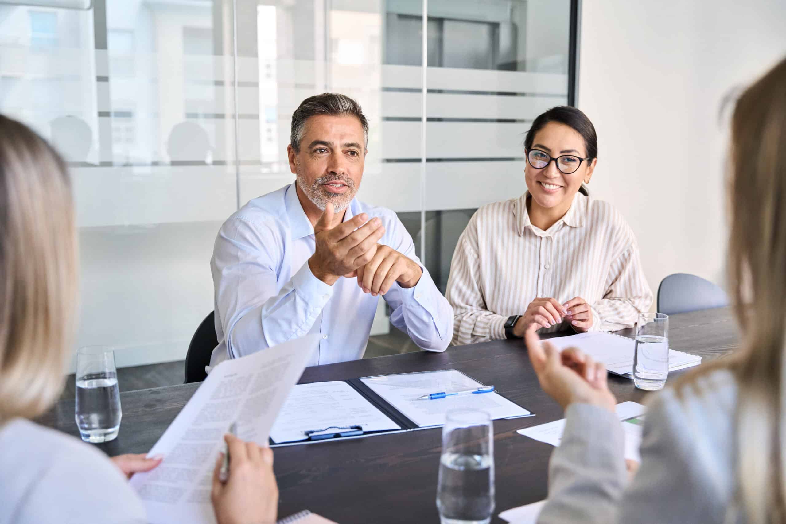 Diverse professional executive team people working at board meeting