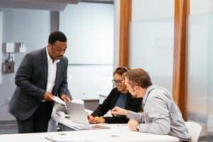 Boss going over over paperwork with two employees