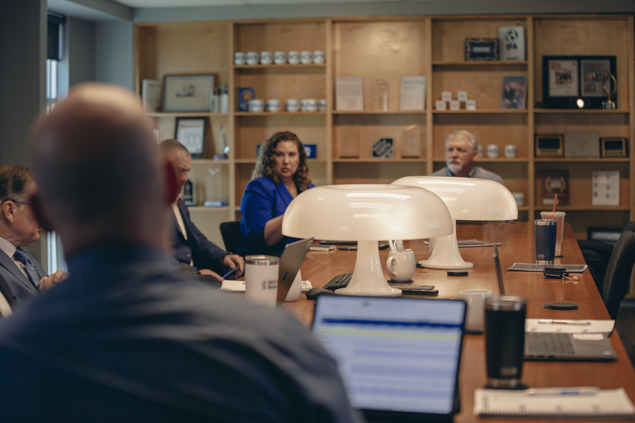 AtWork team members talking and having a meeting in a conference room.