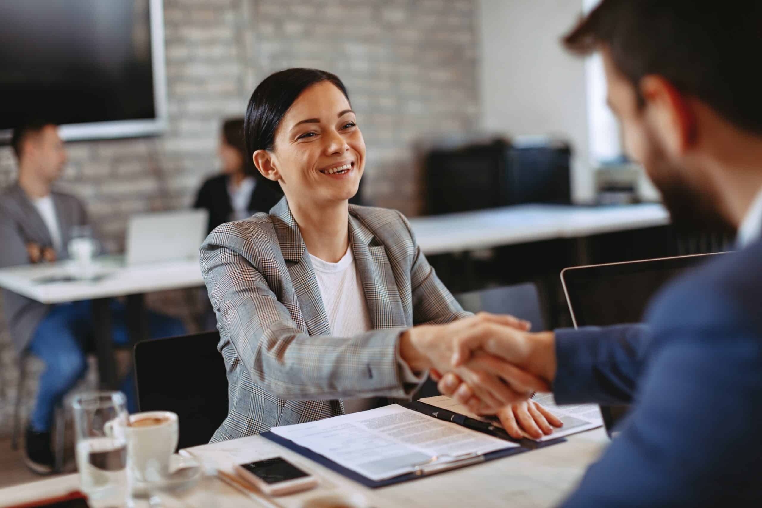 Two businesswoman make a deal and shakehands