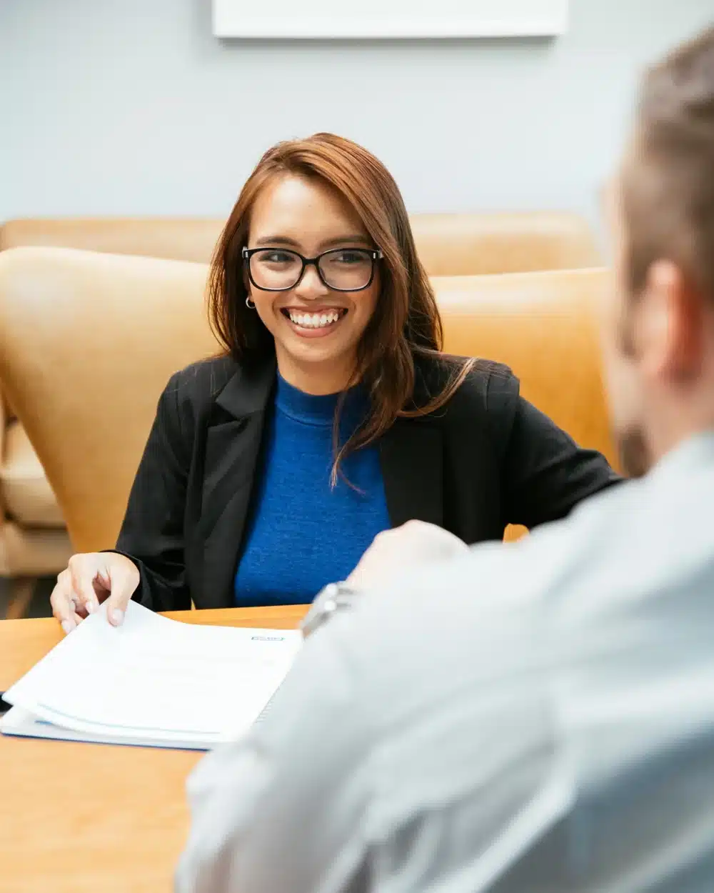 Staffing professional smiling during a meeting across a conference table